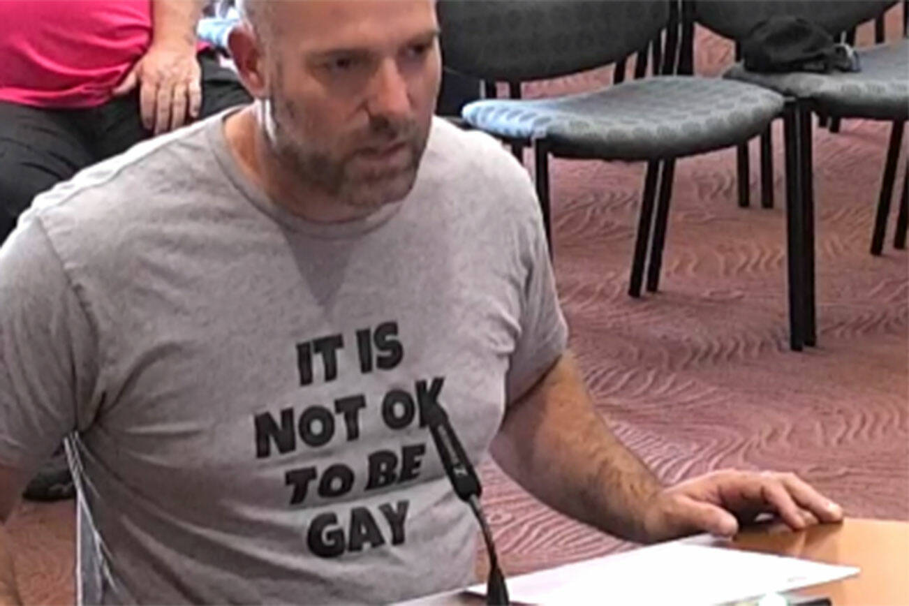 Tyler Shuey/Kitsap News Group 
Daniel Charles Svoboda wears a shirt stating “It is not ok to be gay” at the July 5 Poulsbo City Council meeting.