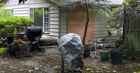 Caution tape surrounds a home on Sunrise Drive that caught fire June 29 and claimed the life of Charles J. Adolfson. Nancy Treder/Kitsap News Group