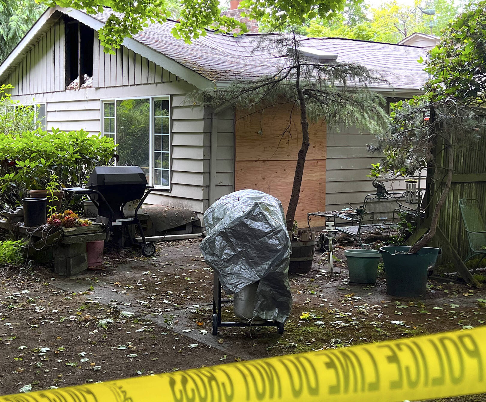 Caution tape surrounds a home on Sunrise Drive that caught fire June 29 and claimed the life of Charles J. Adolfson. Nancy Treder/Kitsap News Group