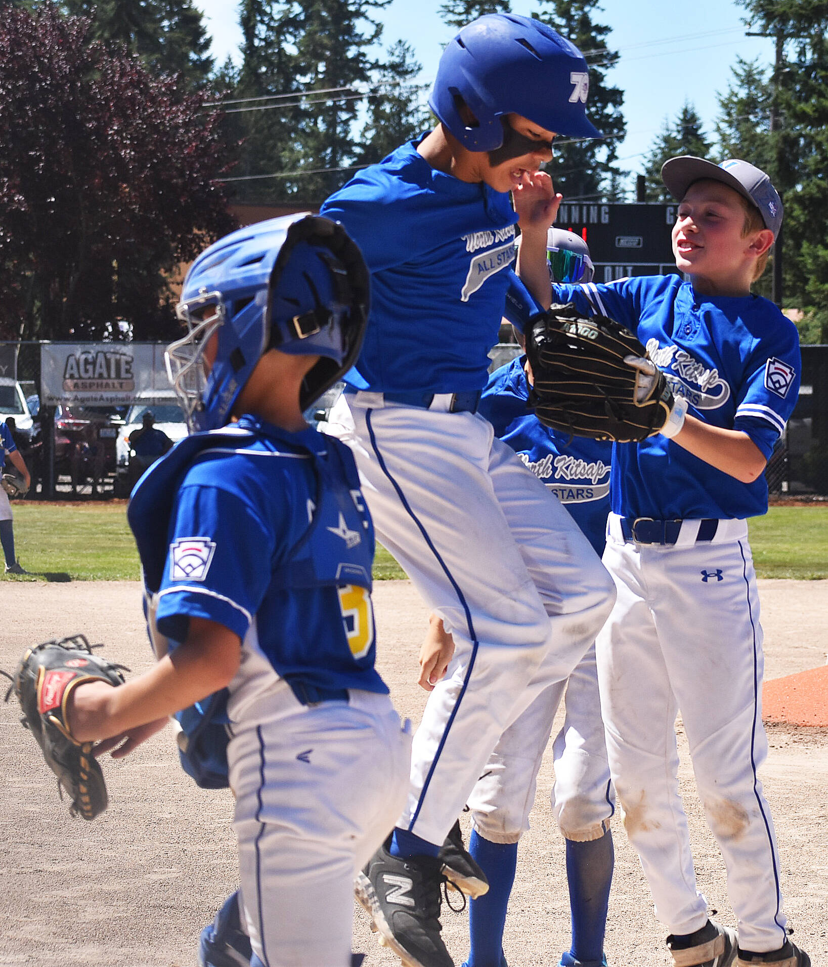 Ellis Slade celebrates with his teammates after hitting a homerun. Nicholas Zeller-Singh/Kitsap News Group Photos