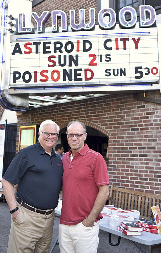 Nancy Treder/Kitsap News Group
Attorney and food safety expert Bill Marler and writer Jeff Benedict pose under the marquee at the Lynwood Theater during the premiere of the documentary, Poisoned: The Dirty Truth About Your Food. The film is set for worldwide release on Netflix Aug. 2.