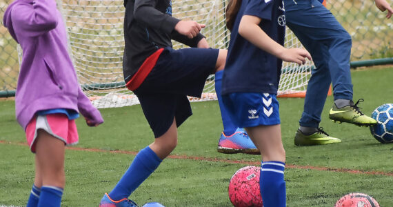 Sydney Leech and Taylor Keaty-Wallorich practice dribbling with Everton coaches. Nicholas Zeller-Singh/Kitsap News Group Photos