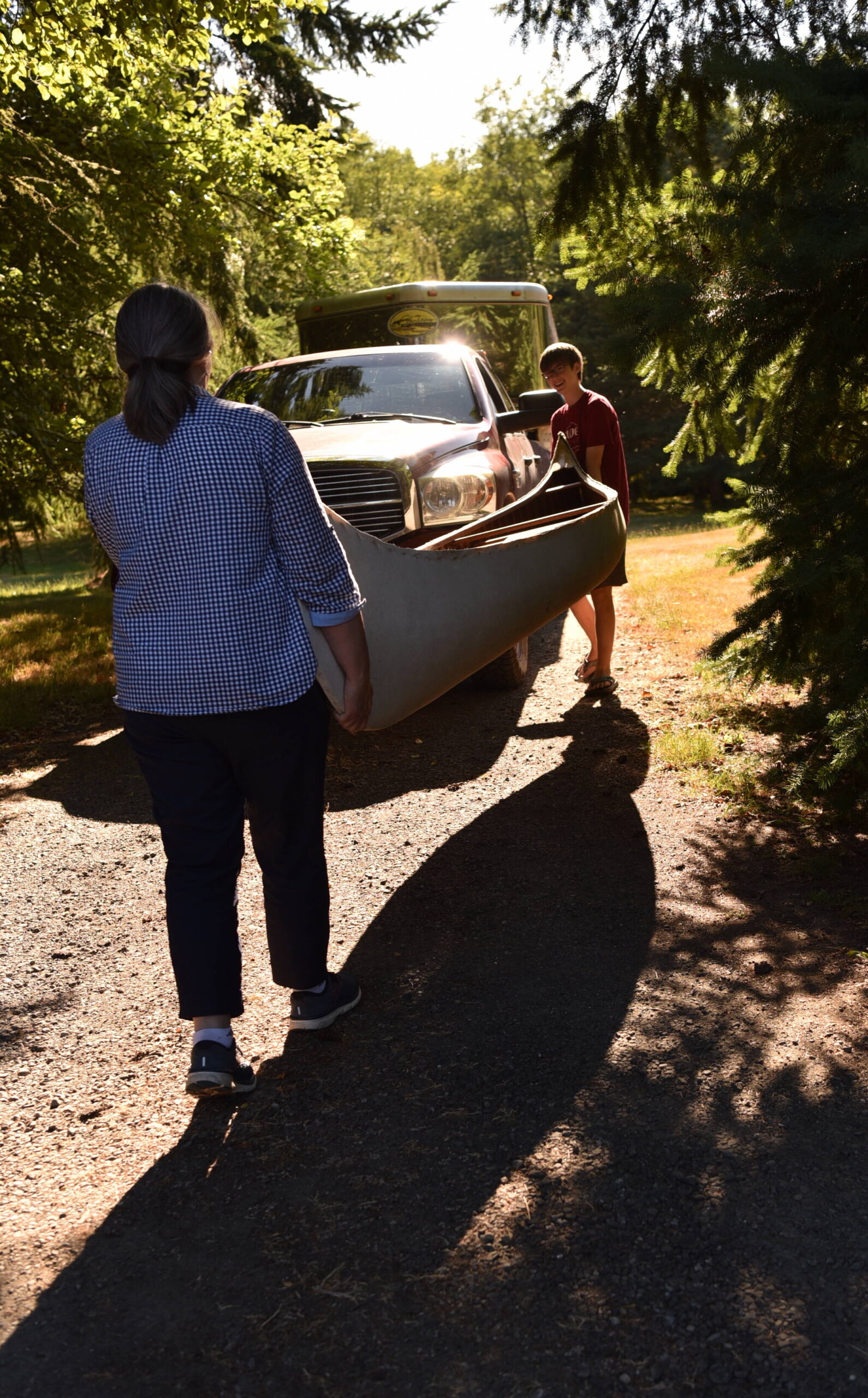 Carrie and Owen Nelson carry the 16-foot canoe to the horse trailer that will take it home to Montana.
