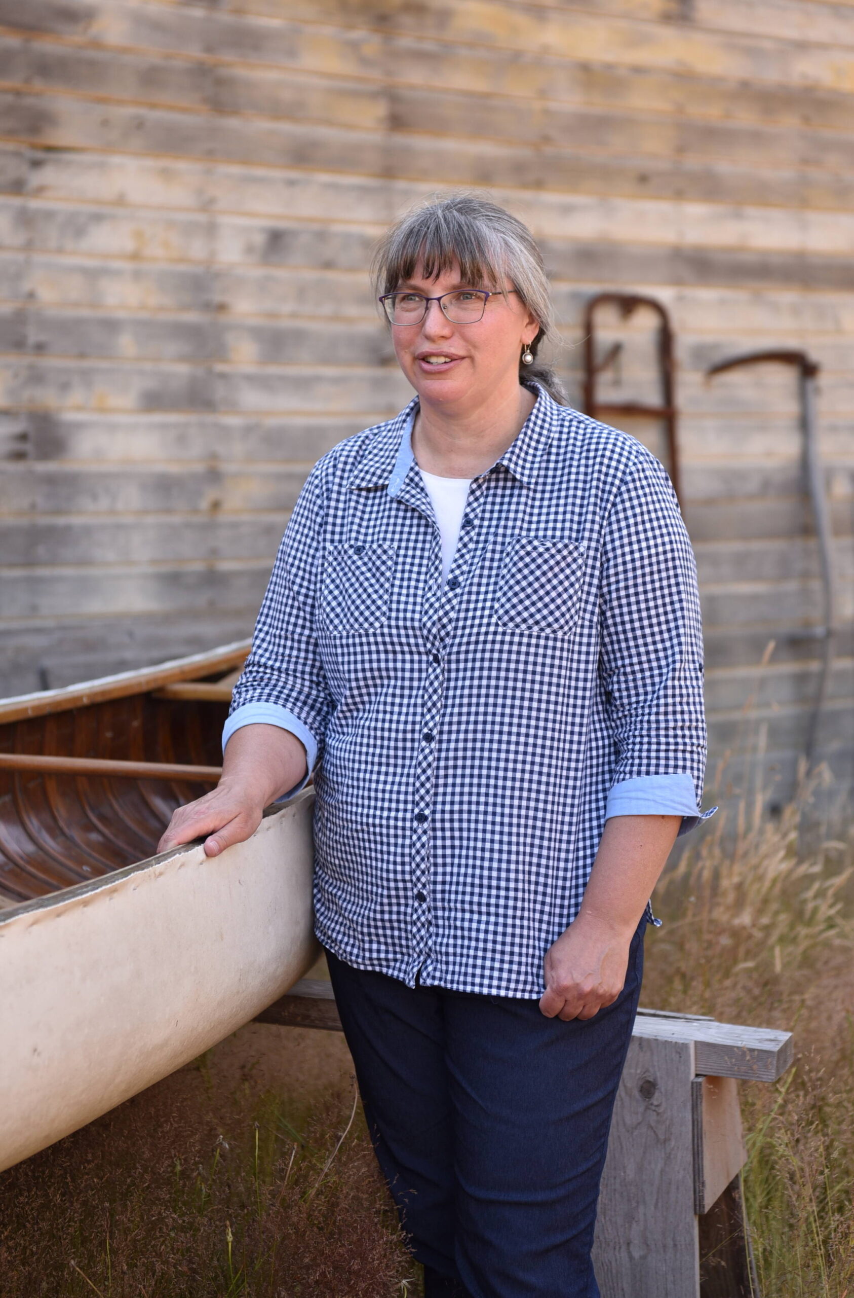 Carrie Nelson, a board member for the Conrad Mansion Museum in Kalispell, MT, gets her first look at the canvas canoe used by Alicia Conrad on her honeymoon in 1906.