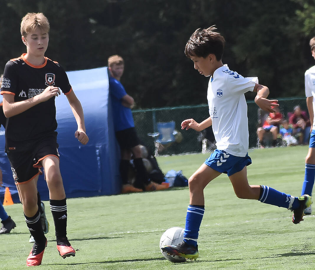 Nicholas Zeller-Singh/Kitsap News Group Photos
The Island Cup, which brings 89 soccer teams of all ages to Bainbridge Island, is taking place this weekend at Battle Point Park, Woodward Middle and Bainbridge High. BI Football Club is one of the teams. Here, Brady Treve dribbles into the opponent’s defense.