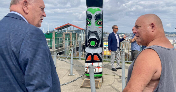 Elisha Meyer/Kitsap News Group Photos
Councilman John Clauson (left) and Bill Martin Jr. (right) connect over the restoration of the totem pole. The pole was a piece dedicated to the late Gerald H. Grosso, whom both men had connections to.
