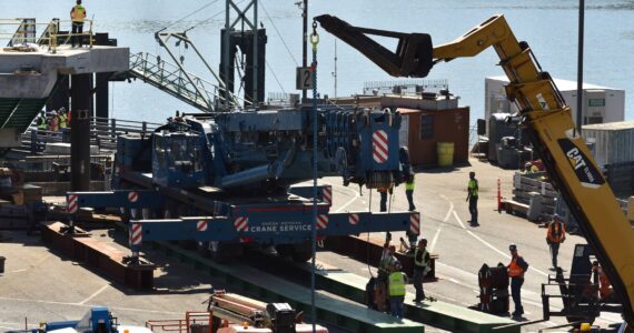 Nancy Treder/Kitsap News Group Photos
Construction workers on the Bainbridge Island ferry terminal prepare to transfer the first of the walkway spans Sept. 8.