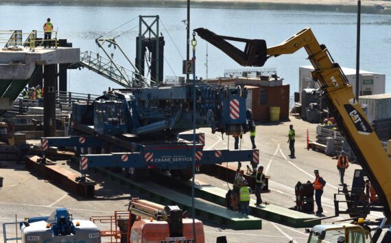 Nancy Treder/Kitsap News Group Photos
Construction workers on the Bainbridge Island ferry terminal prepare to transfer the first of the walkway spans Sept. 8.