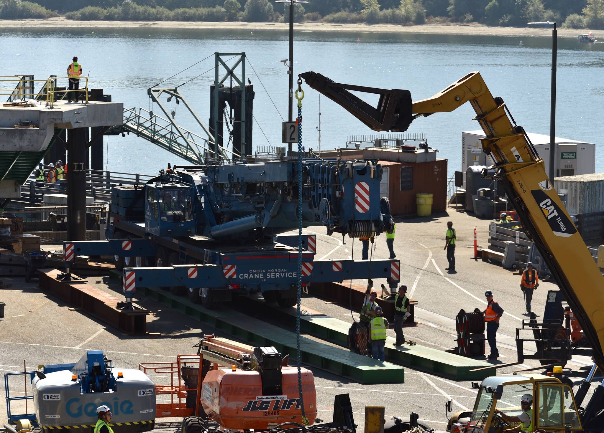 Nancy Treder/Kitsap News Group Photos
Construction workers on the Bainbridge Island ferry terminal prepare to transfer the first of the walkway spans Sept. 8.