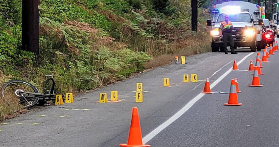 KCSO courtesy photo  
A bicycle lies on the side of the road in Hansville following a hit-and-run collision early Sept. 19 that resulted in critical injuries to a male cyclist who was airlifted to Harborview Medical Center in Seattle. The suspect has been charged.