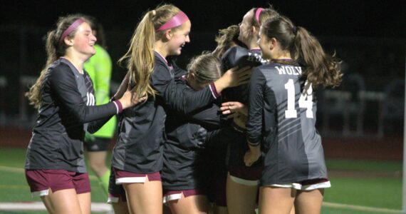 Elisha Meyer/Kitsap News Group
Melanie Rojas-Perez is surrounded by her teammates after securing the game-winning goal on a stoppage-time penalty kick.