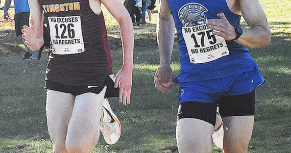 Nicholas Zeller-Singh/Kitsap News Group Photos
Kingston’s Emmanuel Moes and Olympic’s Justin Jaramillo battle to the finish line.