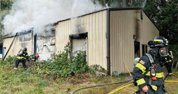 NKF&R courtesy photo
Firefighters work to access a fire Oct. 15 in a North Kitsap building that housed a home-based screen printing business.