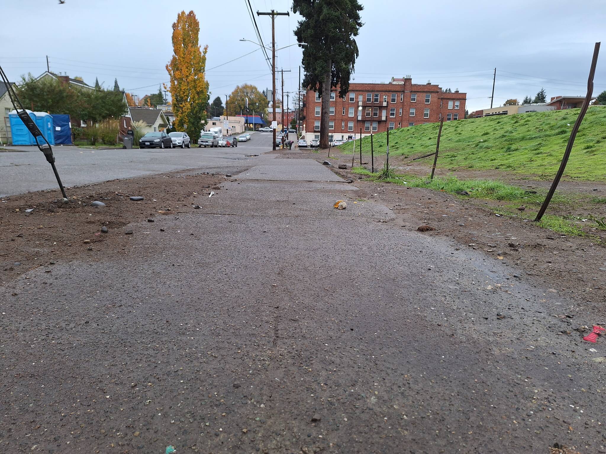 Elisha Meyer/Kitsap News Group Photos
This stretch of sidewalk on Dr. Martin Luther King Way is clear for the first time in months, signs of what was there before the Nov. 4 cleanup still implanted in the ground.