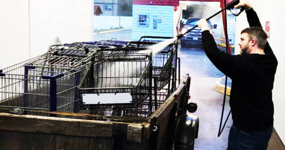 Sponsor-A-Can courtesy photos
Matthew Boisson uses a car wash hose to spray off multiple carts in the back of a truck.