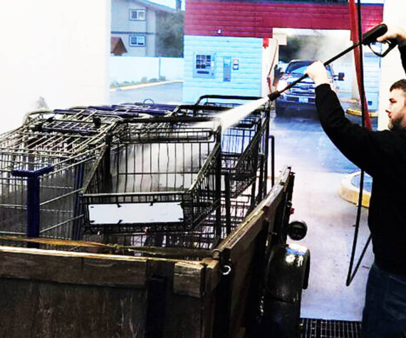 Sponsor-A-Can courtesy photos
Matthew Boisson uses a car wash hose to spray off multiple carts in the back of a truck.