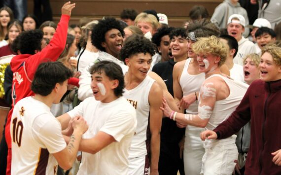 Elisha Meyer/Kitsap News Group Photos
Senior Kenny Miller smiles as the South Kitsap students celebrate on the court.
