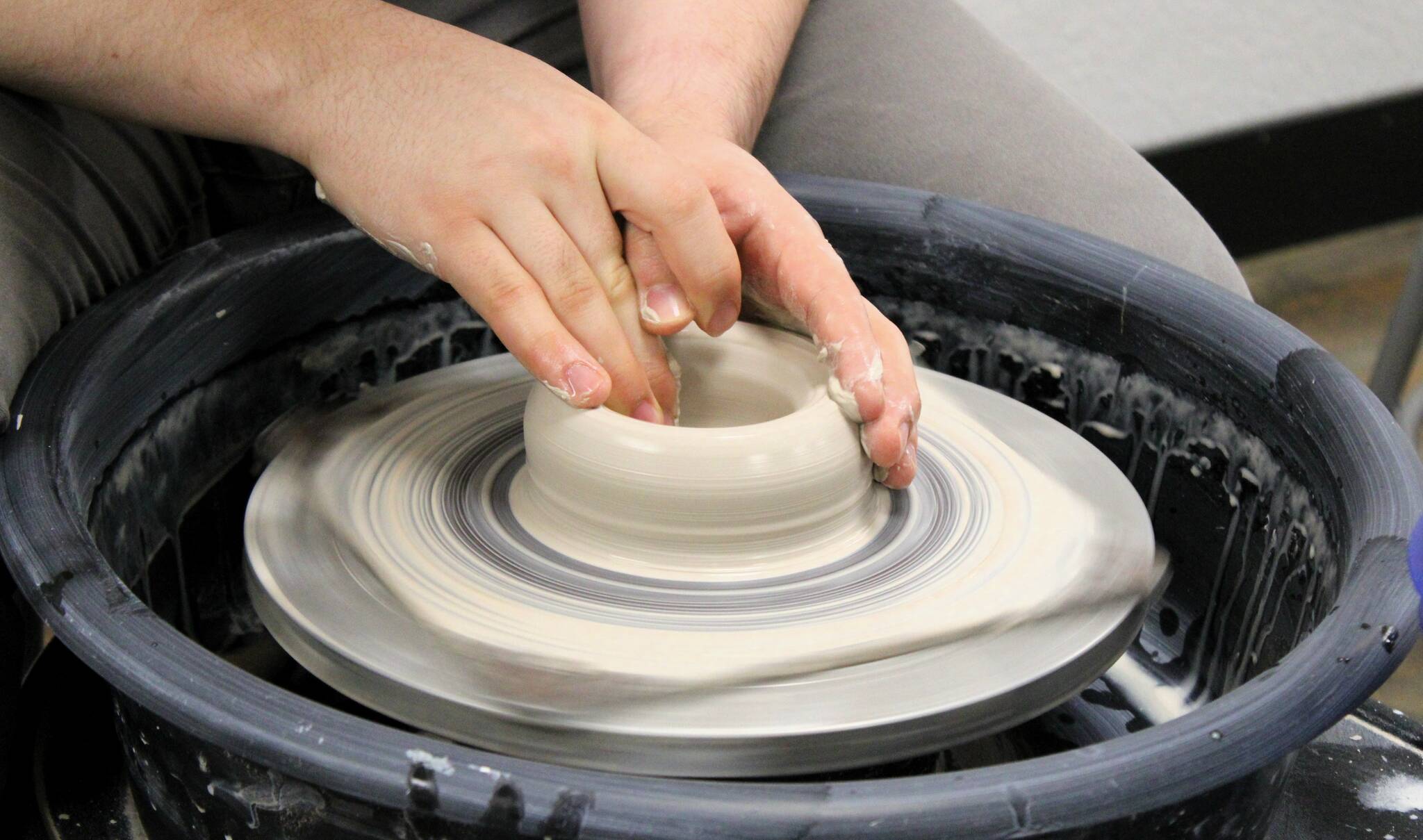 Elisha Meyer/Kitsap News Group Photos
The hands of Jacob Cowan shape the clay on a spinning wheel in his new pottery studio in Port Orchard.