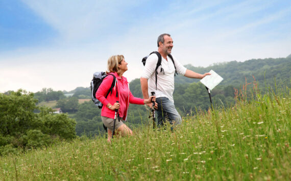 Senior couple hiking in natural landscape