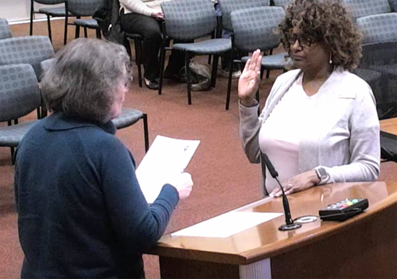 Pam Crowe is sworn into council by Mayor Becky Erickson.