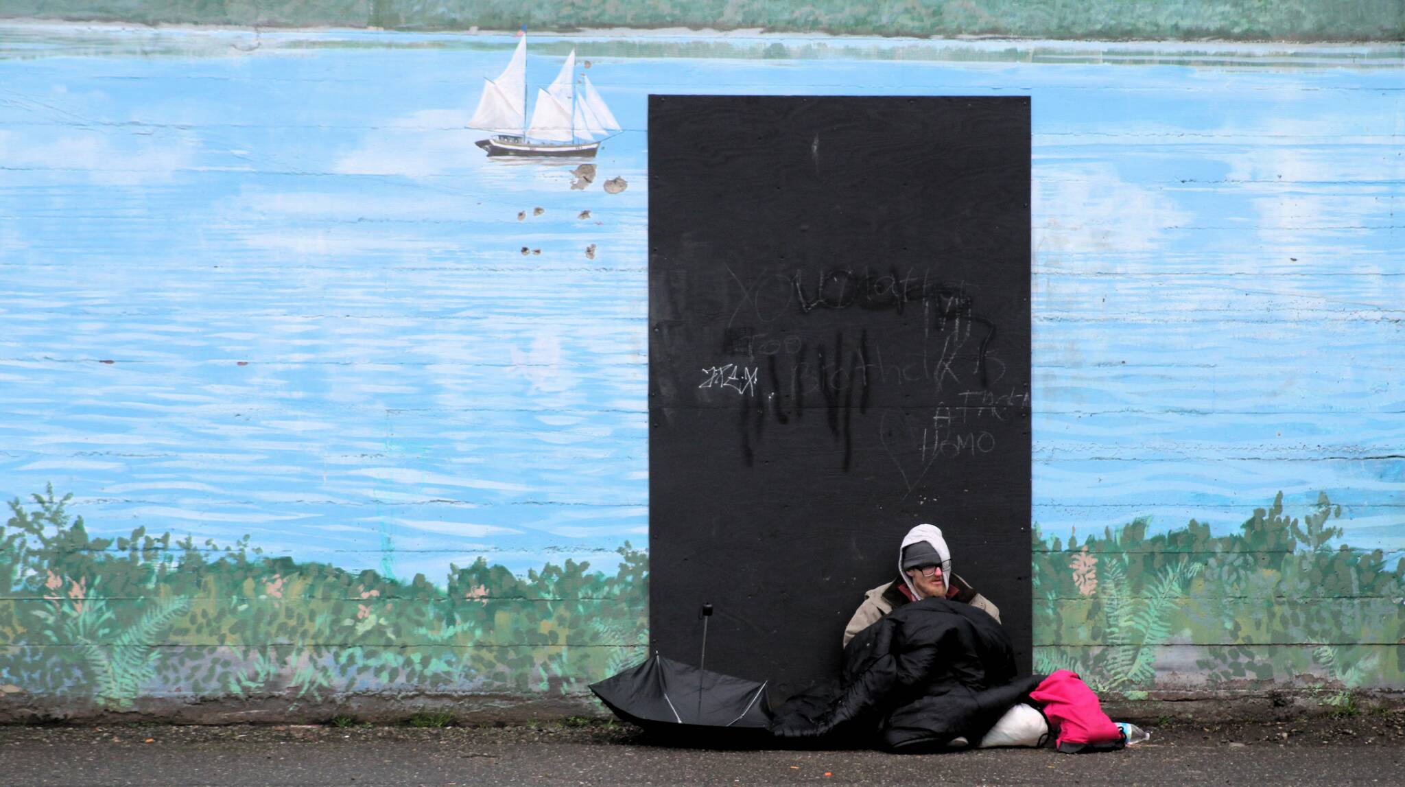 Elisha Meyer/Kitsap News Group Photos
A homeless man sits against the wall of the Kitsap Rescue Mission building on 6th Street.