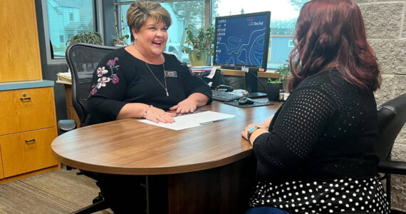First Fed Branch Manager Robin Bookter reviews options with an account holder in Sequim.