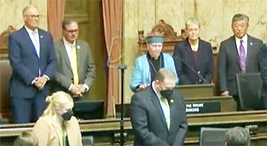 Steve Powell/Kitsap News Group
Rev. Dee Eisenhower of Bainbridge Island gives the opening prayer at Gov. Jay Inslee’s State of the State address.