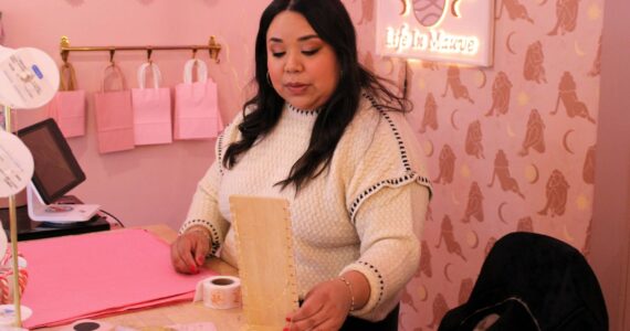Elisha Meyer/Kitsap News Group
Nayeli Rivera works at the desk of her new Life in Mauve storefront in Manette.
