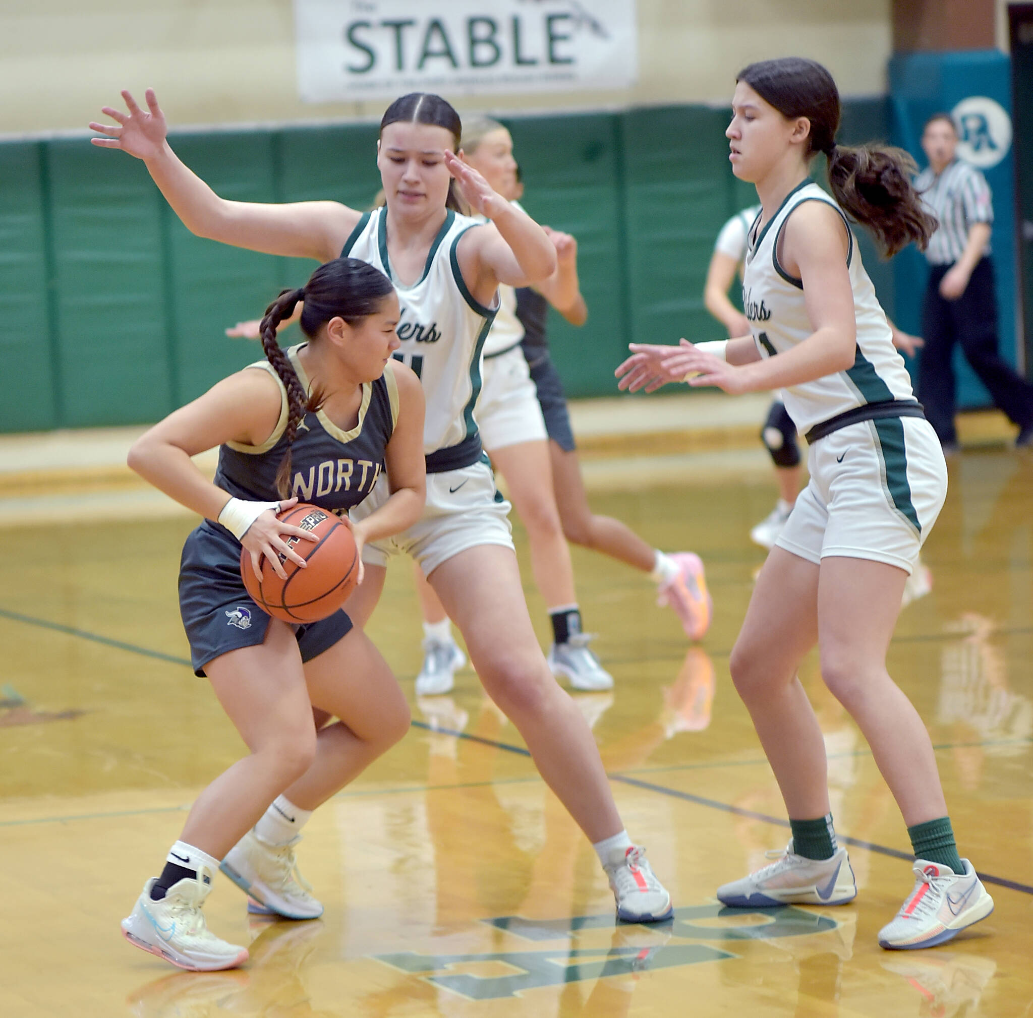 Keith Thorpe courtesy photos
North Kitsap’s Tiffany Le, left, tries to evade the defense of Port Angeles’ Lexie Smith, center, and Lindsay Smith, right, on Tuesday at Port Angeles High School.