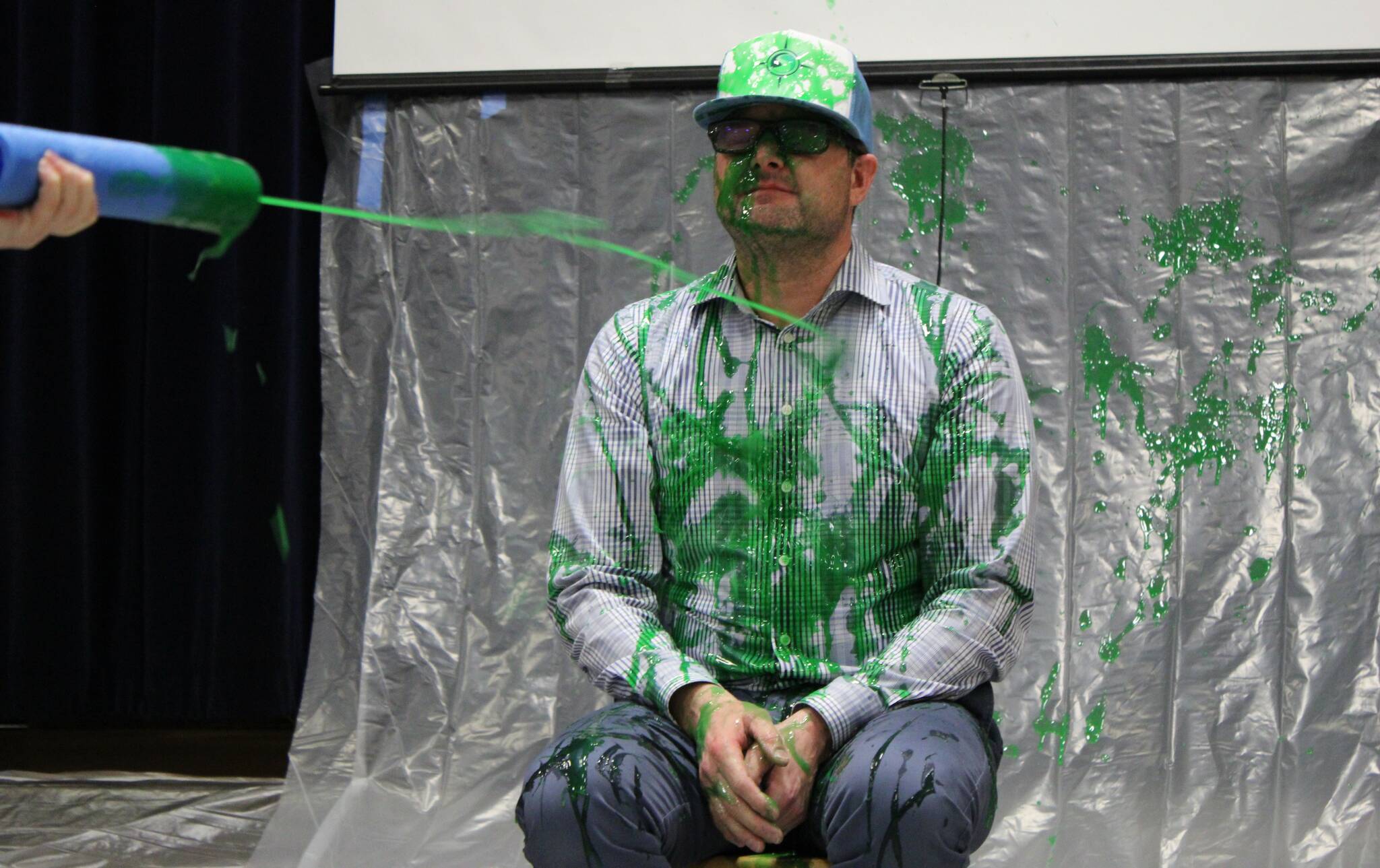 Headshot! Principal Ted Macomber takes a shot of slime to the face.