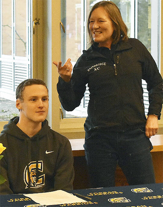 Nicholas Zeller-Singh/Kitsap News Group
Bodie Strom, shown with Bainbridge coach Ann Howard Lindquist, signs a letter of intent to run in college.