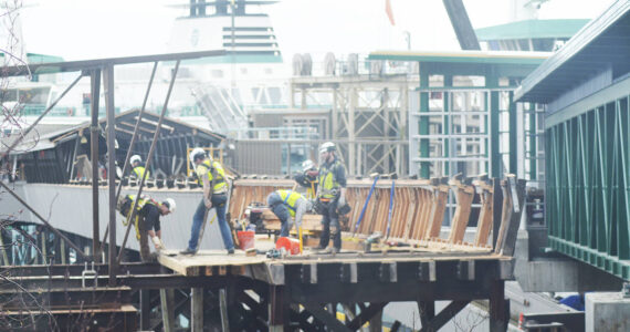 Steve Powell/Kitsap News Group Photos
A big group of workers is tearing down the old ferry passenger overpass on Bainbridge Island as the new one at right is now operational.