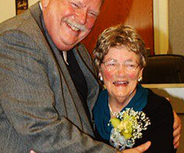 File Photo
Councilmember John Clauson hugs Carolyn Powers during her 2013 retirement ceremony at City Hall.