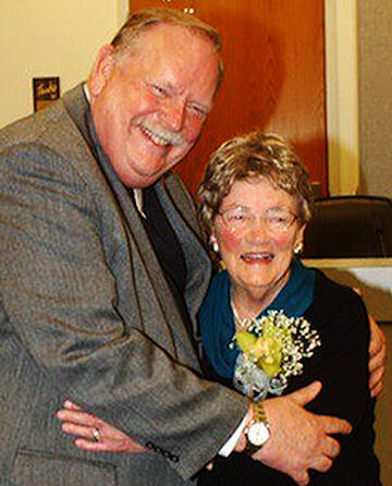 File Photo
Councilmember John Clauson hugs Carolyn Powers during her 2013 retirement ceremony at City Hall.