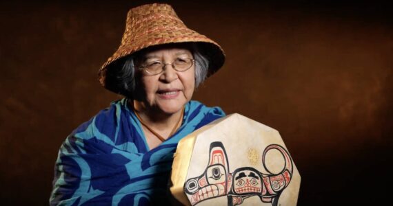 Molly Hetherwick/Kitsap News Group
Indipino elder Bethany Mapanao displays the drum her brother painted for her with an image of her animal, a wolf. She is also wearing a woven cedar hat from the Lummi tribe, which she “wears with pride.”