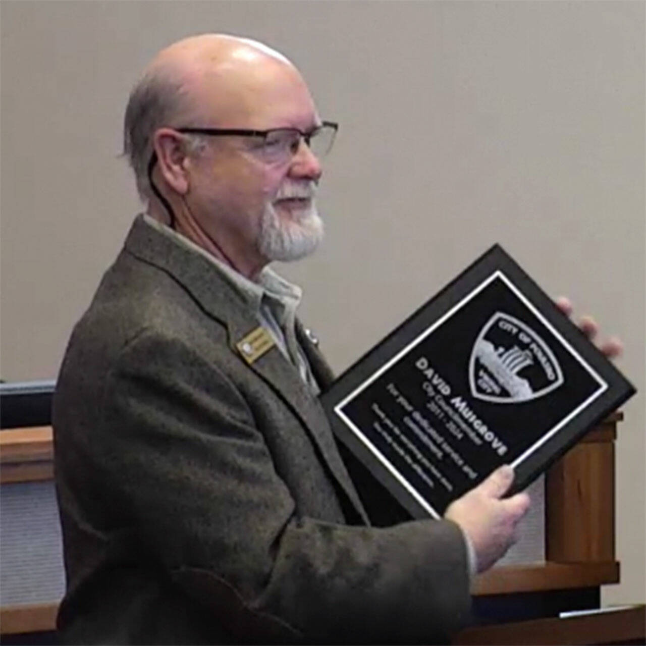 City of Poulsbo courtesy photos
Outgoing councilmember David Musgrove receives a plaque from the city at his last meeting March 20.