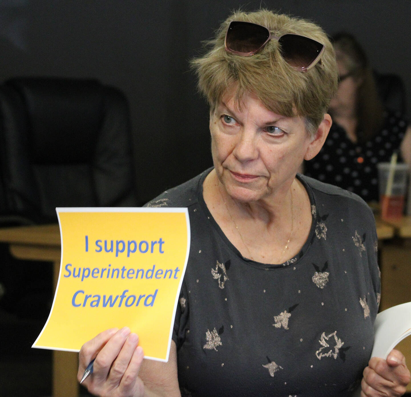 Elisha Meyer/Kitsap News Group photos
Former Bremerton Mayor Lynn Horton hands out signs to members of the public in protest of the decision.