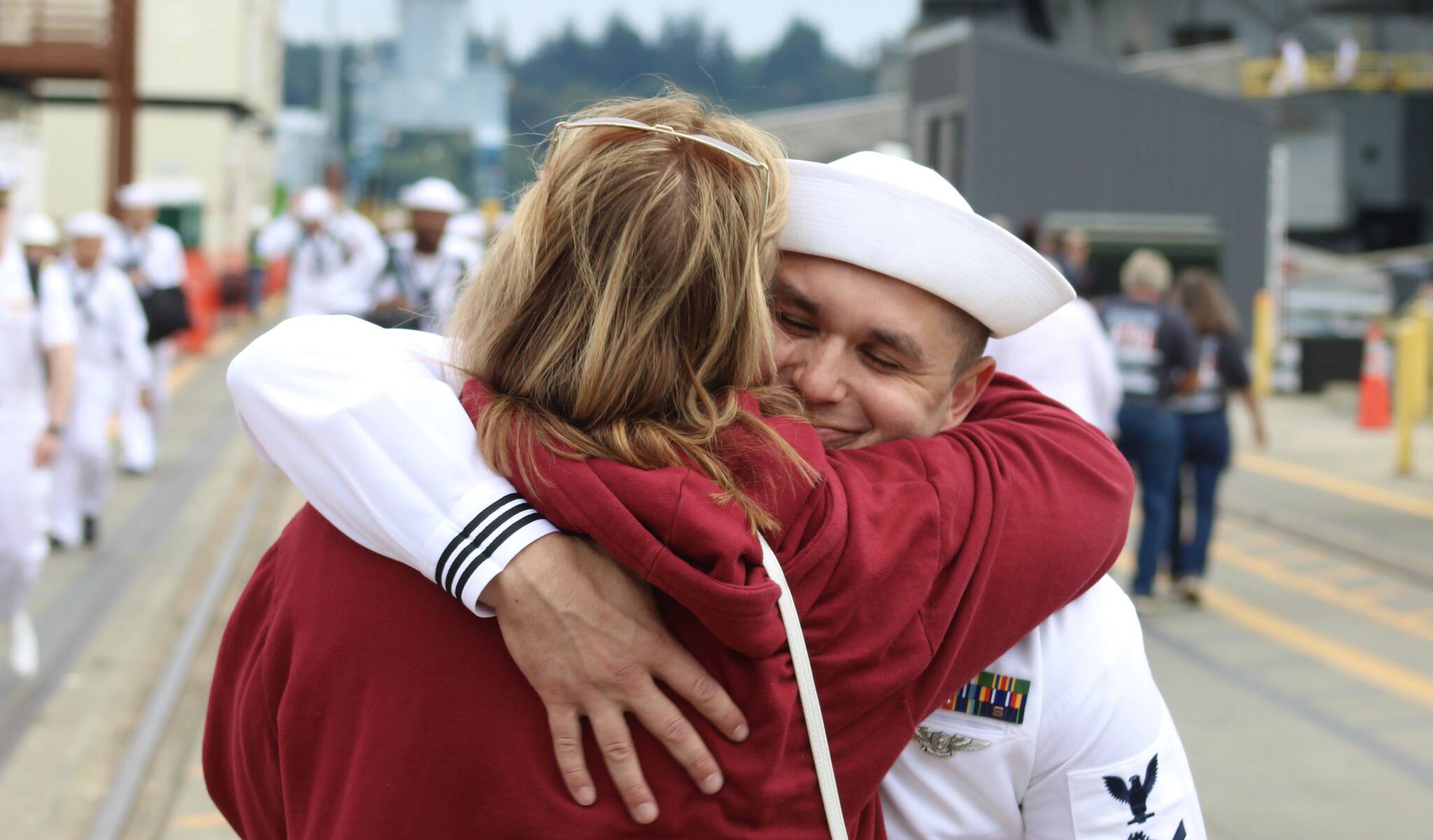 Elisha Meyer/Kitsap News Group photos
Adam Lachman is wrapped in an embrace by family upon his arrival to Bremerton aboard the USS Ronald Reagan.