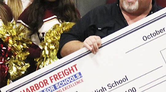 Harbor Freight courtesy photo
South Kitsap High School trades teacher Jeff Winn celebrates receiving a check for $100,000 for himself and his school program Oct. 8.
