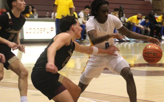 Luke Caputo/Kitsap News Group photos
Enoch Taylor of Bremerton avoids incoming Lakewood defenders in a 62-44 Knight win in the first round of the 2A state boys basketball tournament at the University of Puget Sound in Tacoma March 1.
