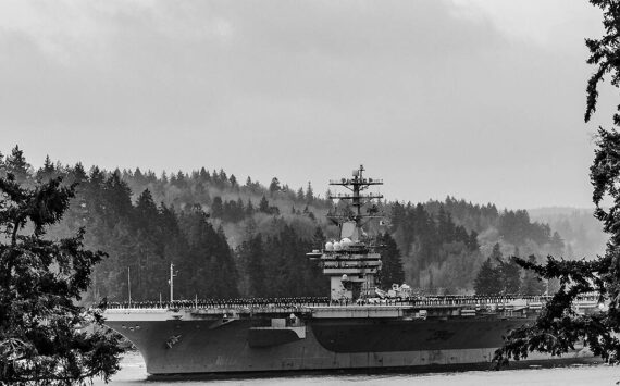 Patrick Coonan courtesy photo
The aircraft carrier USS Nimitz goes through Rich Passage on an early foggy morning March 21 after leaving Bremerton with its sailors on its deck on its way to retirement in Norfolk, VA.