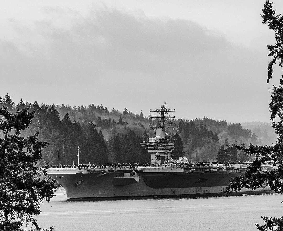Patrick Coonan courtesy photo
The aircraft carrier USS Nimitz goes through Rich Passage on an early foggy morning March 21 after leaving Bremerton with its sailors on its deck on its way to retirement in Norfolk, VA.