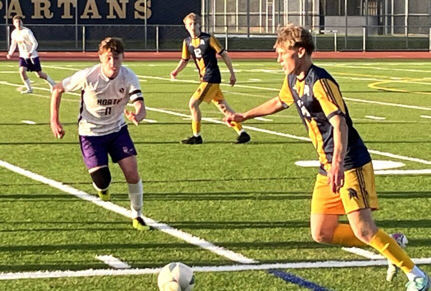 <p>Luke Caputo/Kitsap News Group photos</p>
                                <p>Spartan Sampson Murchie dribbles the ball downfield with Viking defender Ethan Peck closing in during a 4-1 Bainbridge win over North Kitsap April 18 at Bainbridge High School.</p>