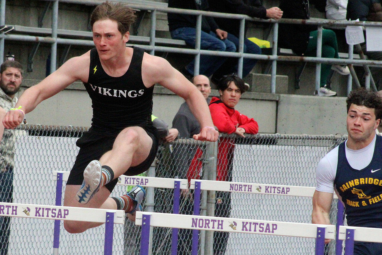 Luke Caputo/Kitsap News Group photos
Viking Theo Sterns, left, competes in a hurdling event with a Bainbridge runner on his heels April 19 at the Lil’ Norway Invitational track meet at North Kitsap High School.
