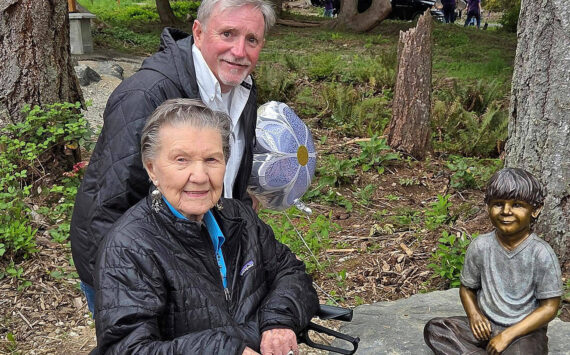 Poulsbo Parks and Recreation courtesy photos
99-year-old Ardis Morrow, front, and artist Jeff Oens stand next to the statue of Eli Creekmore at Rotary Morrow Community Park in Poulsbo April 19.
