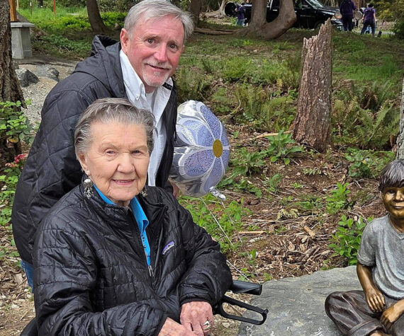 Poulsbo Parks and Recreation courtesy photos
99-year-old Ardis Morrow, front, and artist Jeff Oens stand next to the statue of Eli Creekmore at Rotary Morrow Community Park in Poulsbo April 19.