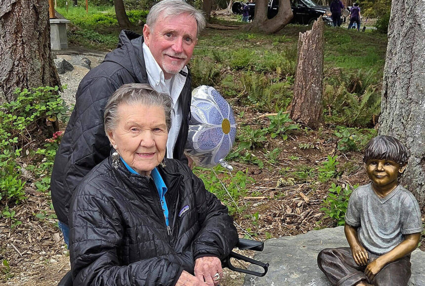<p>Poulsbo Parks and Recreation courtesy photos</p>
<p>99-year-old Artis Morrow, front, and artist Jeff Oens stand next to the statue of Eli Creekmore at Rotary Morrow Community Park in Poulsbo April 19.</p>