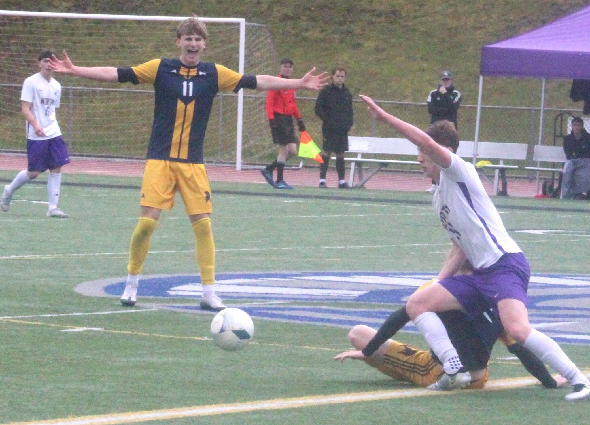 Luke Caputo/Kitsap News Group photos
Spartan Finley Reynolds makes a gesture over a slide tackle in a Bainbridge district championship win over NK May 17.