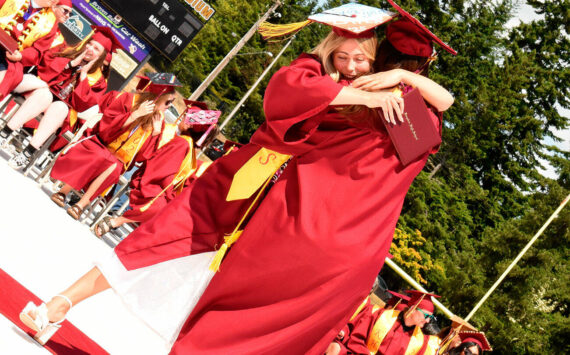 Katrina Daroff/Kitsap News Group photos
Two Kingston High School graduates hug in celebration after receiving their diplomas.