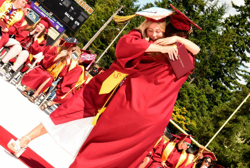 <p>Katrina Daroff/Kitsap News Group photos</p>
                                <p>Two Kingston High School graduates hug in celebration after receiving their diplomas.</p>